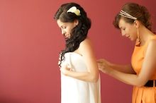 fotografia ślubna, Zgierz – przyjaciółka pomaga pannie młodej w przygotowaniach do ślubu.